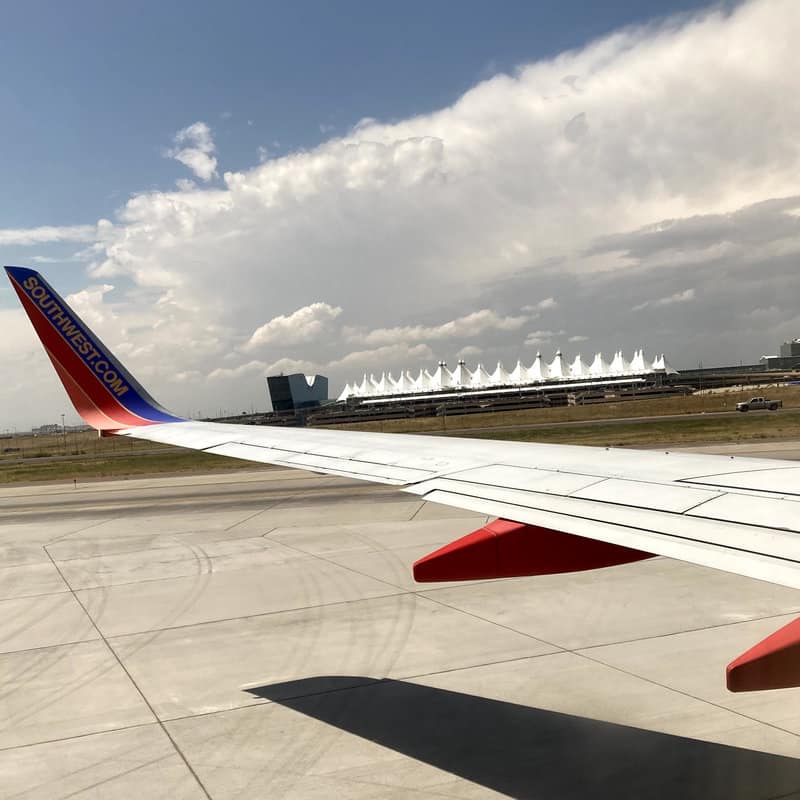 View of Denver airport and wing of Southwest airplane