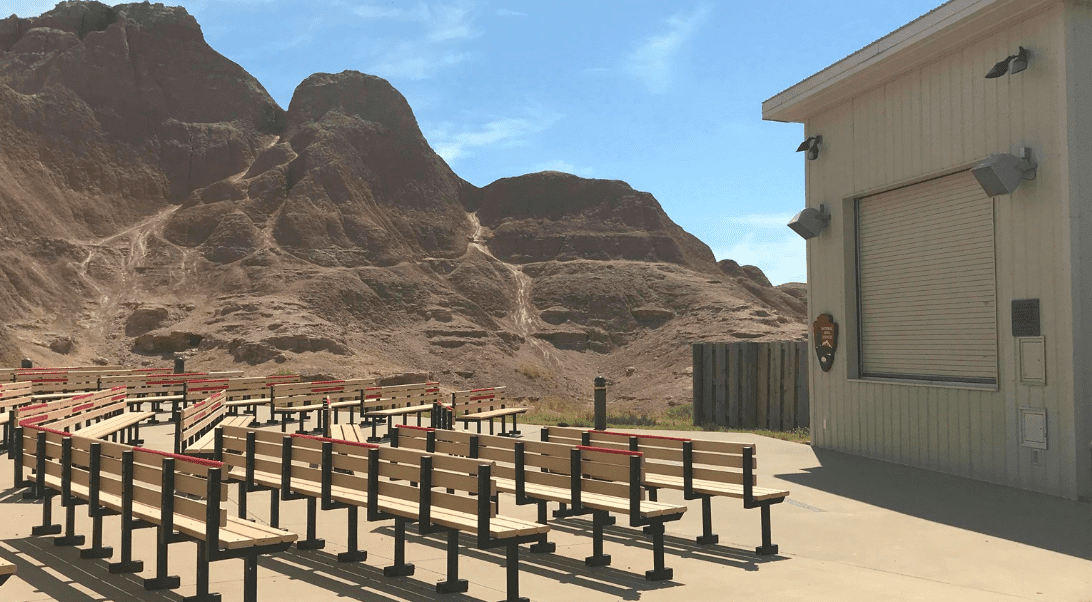 Outdoor seating area for presentations at Badlands National Park, mountains in background