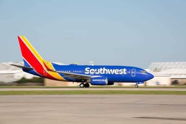 A Southwest Airlines plane is taking off on the runway according to their flight schedule.