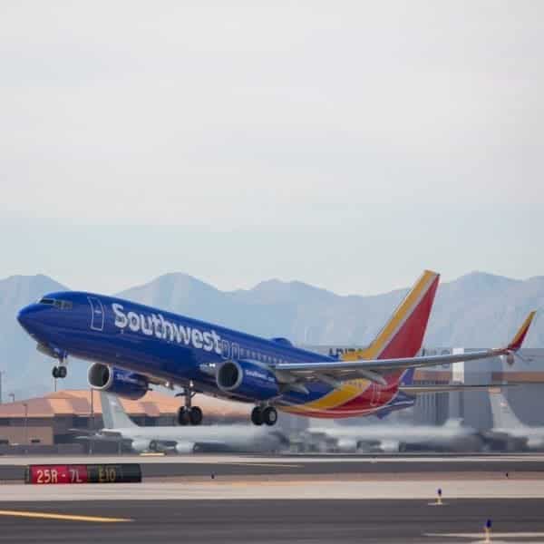 A southwest airlines plane is taking off from the runway.